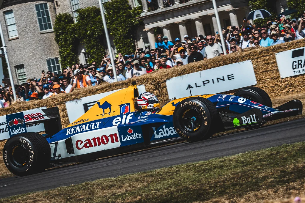 A classic Williams Formula 1 car passing the crowd