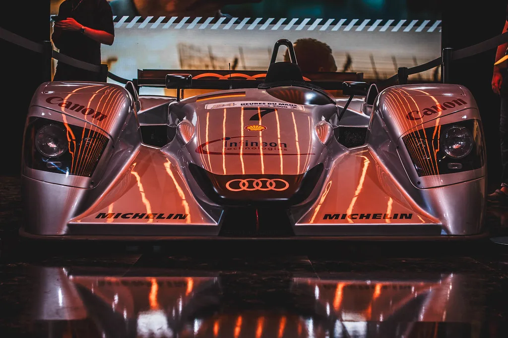An Audi endurance race car lit in orange